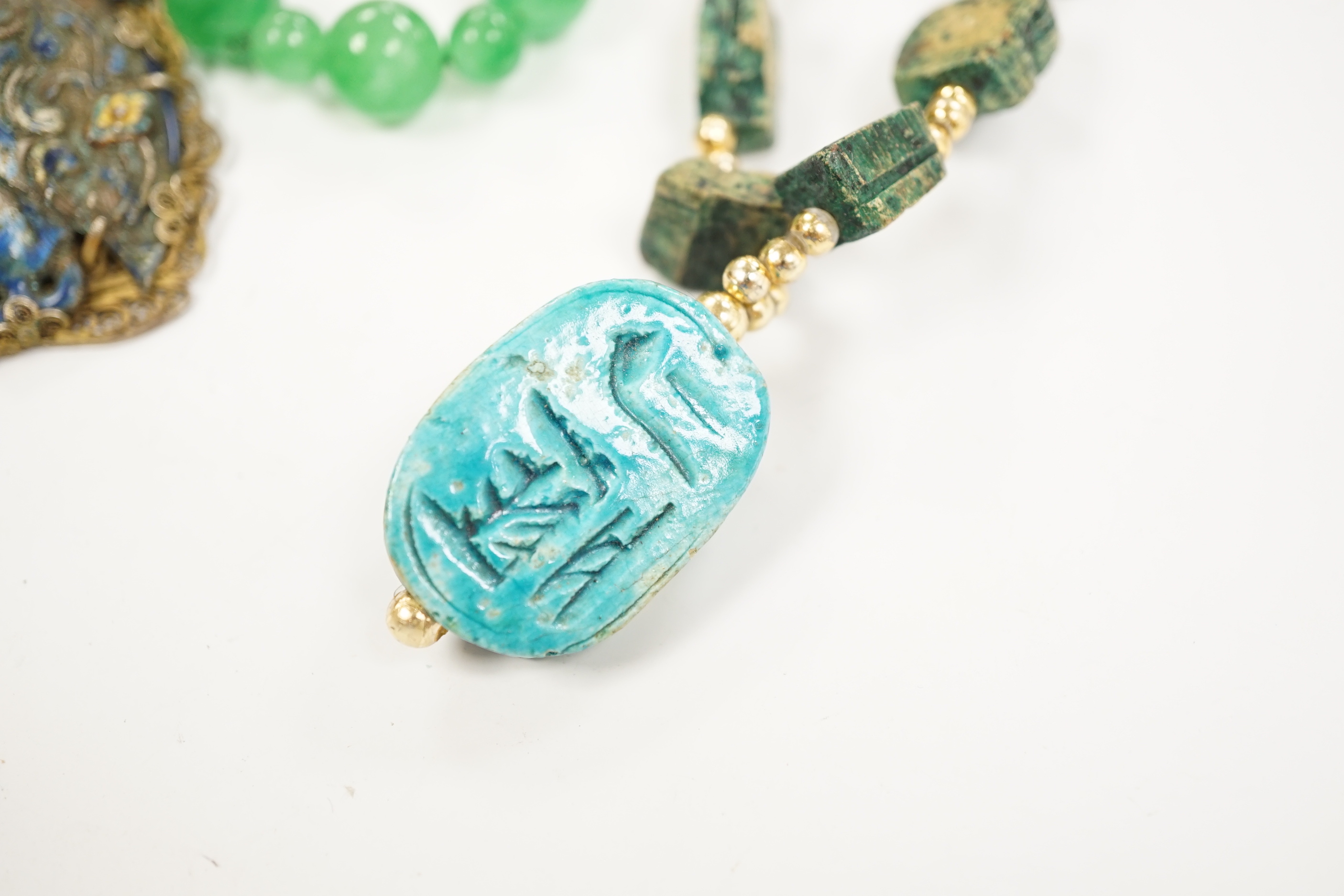 Three assorted Chinese bead necklaces including filigree gilt white metal and enamel pendant necklace, overall 68cm and a jade bracelet.